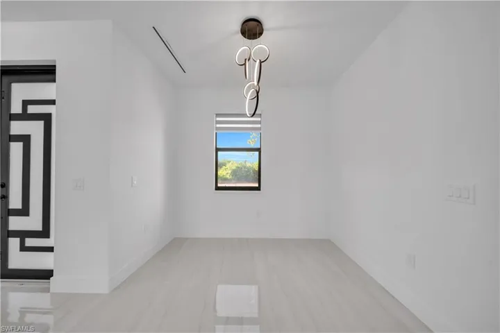 Unfurnished dining area featuring baseboards