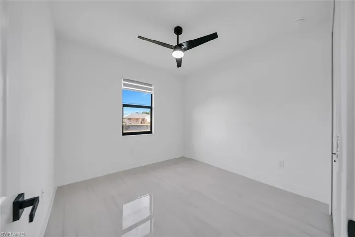 Spare room with a ceiling fan and light wood-type flooring