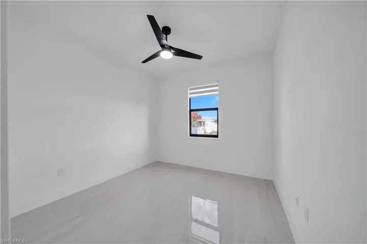 Spare room with baseboards and a ceiling fan