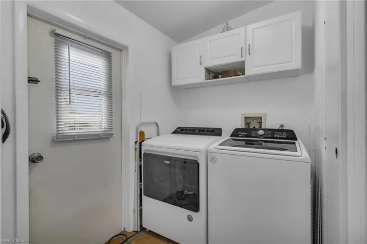 Clothes washing area with washing machine and dryer and cabinet space
