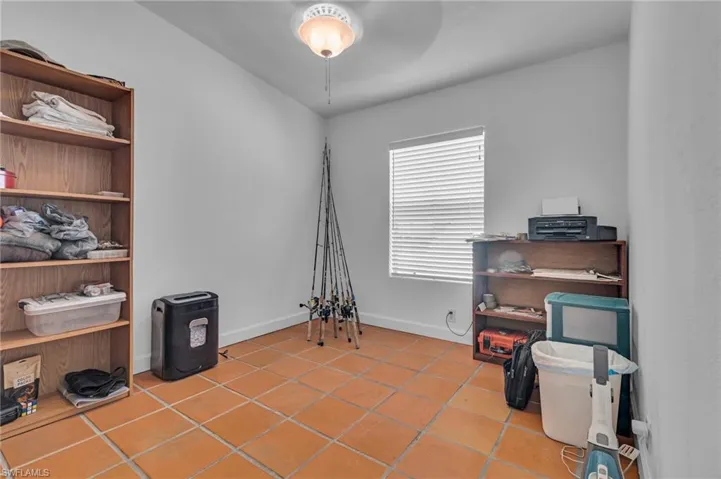 Misc room or bedroom featuring baseboards and tile patterned floors