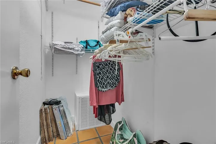 Spacious closet with light tile patterned floors and visible vents