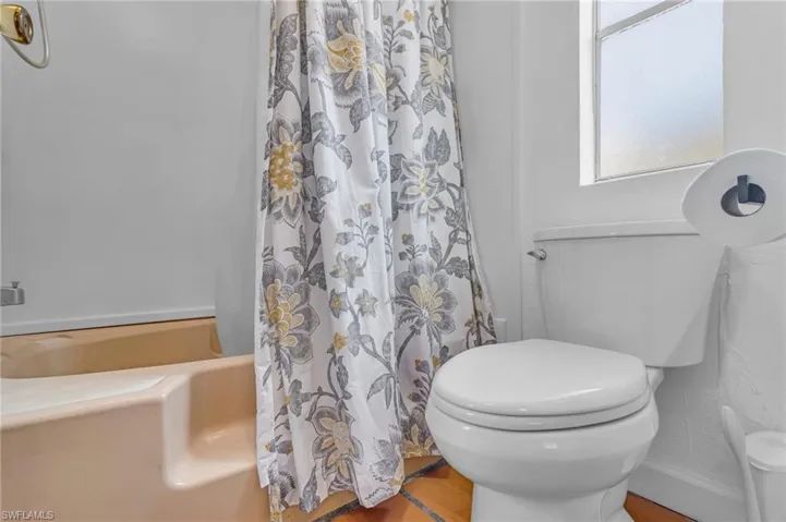Bathroom with toilet and a shower with shower curtain