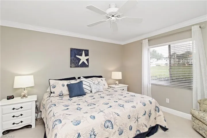 Primary bedroom with king sized bed and adjoining bath and walk-in closet