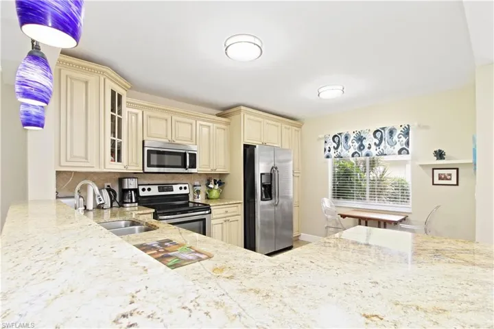 Kitchen features ivory glazed cabinets, granite counters and and S/S appliances