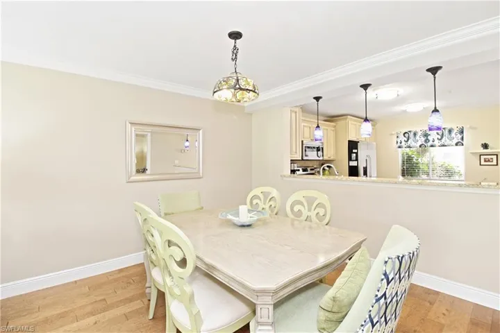 Dining area open to kitchen with pendant lights