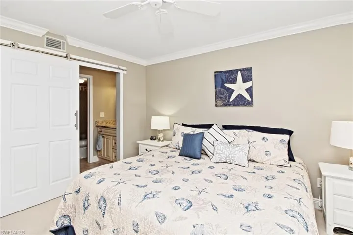 Primary bedroom with barn door to privitize adjoing bath with walk-in shower.