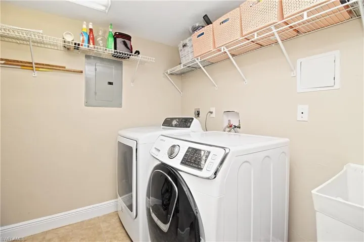 Large laundry room with utility sink.
