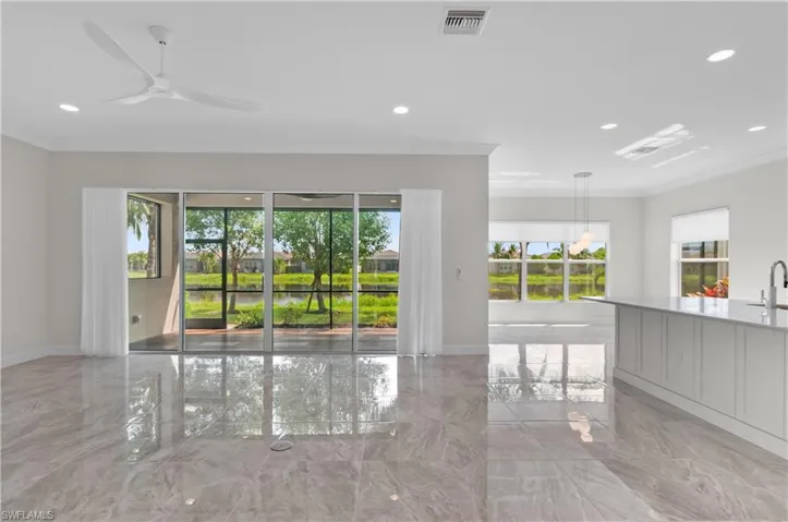 Great Room with ceiling fan and crown molding