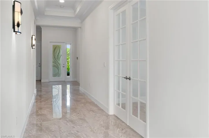 Entry Hall with crown molding and wall sconces