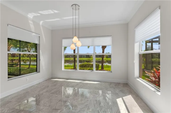 Dining area with a wealth of natural light and crown molding