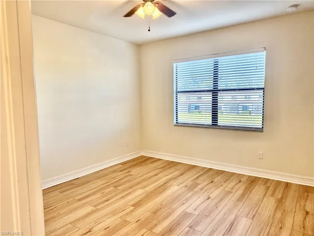 Unfurnished room featuring light wood-style floors and ceiling fan