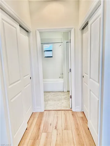 Corridor featuring light wood finished floors