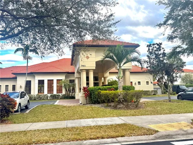 Mediterranean / spanish home featuring a tiled roof, a front lawn, and uncovered parking