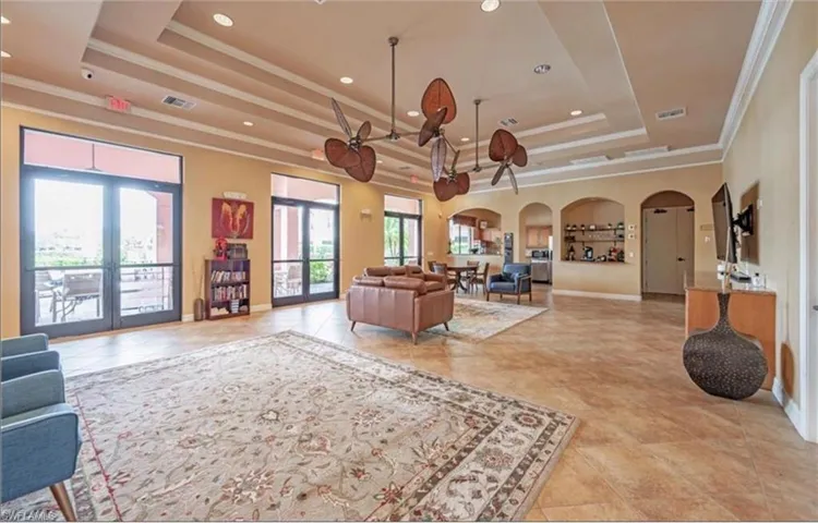 Community lobby featuring crown molding, a raised ceiling, and recessed lighting