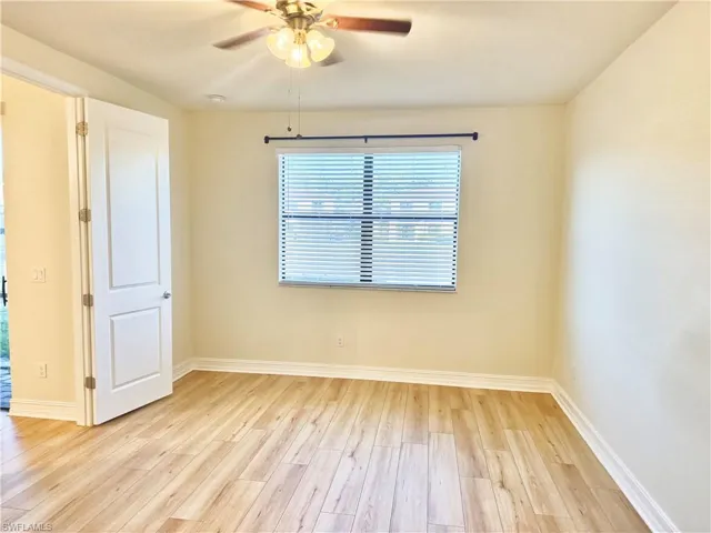Unfurnished room featuring light wood-style flooring and a ceiling fan