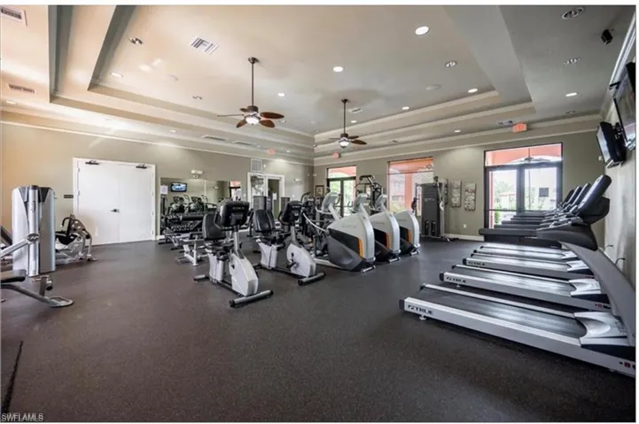 Exercise room with recessed lighting, a ceiling fan, and ornamental molding