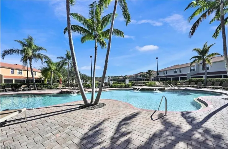 Community pool with a patio