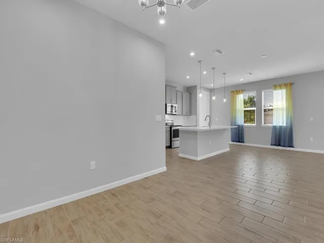 Unfurnished dining room featuring an inviting chandelier