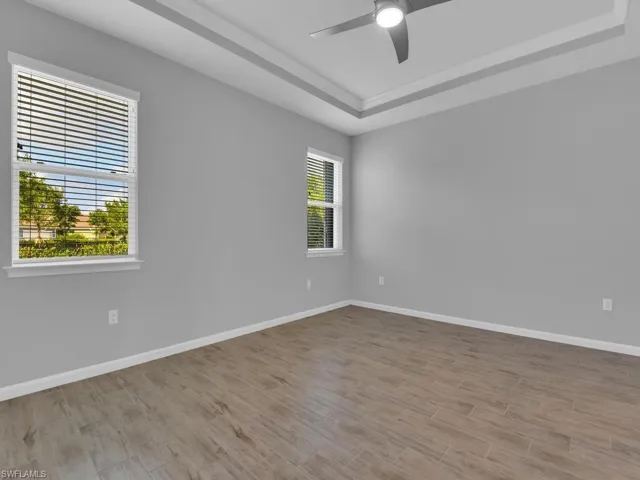 Spare room featuring tile flooring andl a healthy amount of sunlight, and ceiling fan