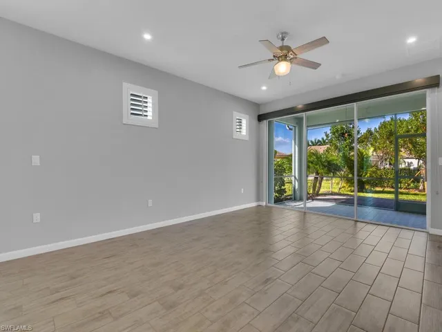 Living room with light tile flooring and ceiling fan