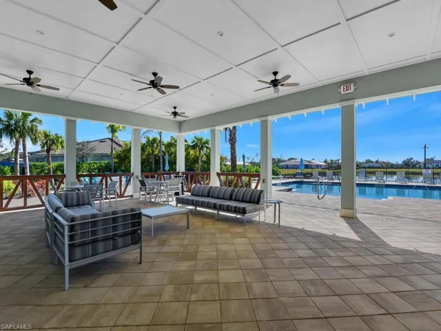 View of patio with a community pool, outdoor lounge area, and ceiling fan