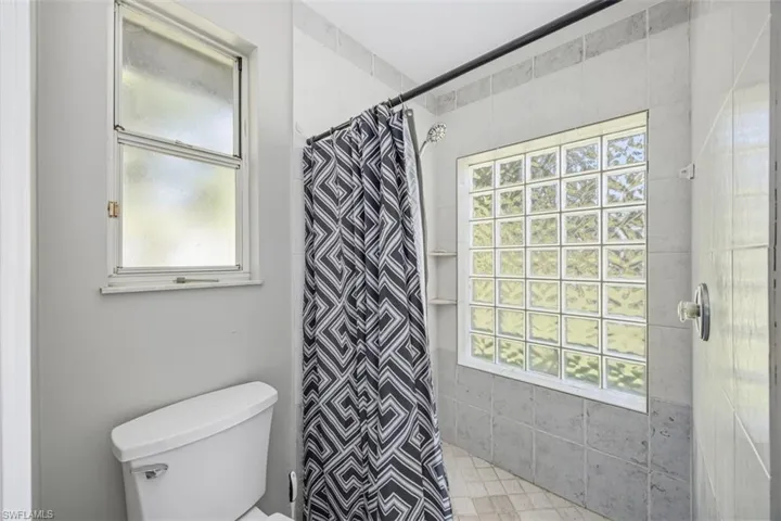 Full bath featuring a shower stall and plenty of natural light