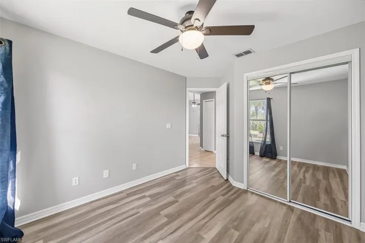 Unfurnished bedroom with light wood finished floors, a ceiling fan, and a closet