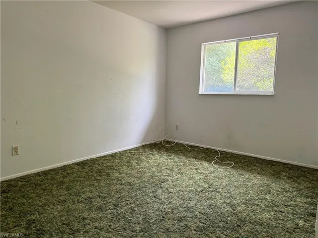 Empty room with carpet floors
