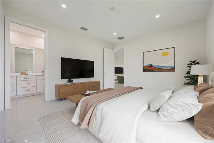 Bedroom with recessed lighting, marble finish floor, visible vents, and connected bathroom