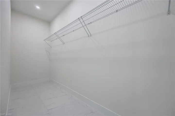 Walk in closet with marble finish floor
