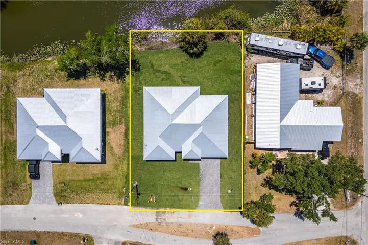 Birds eye view of property with a water view