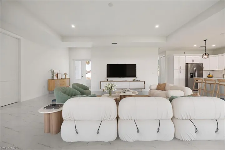 Living area with recessed lighting and marble finish floor