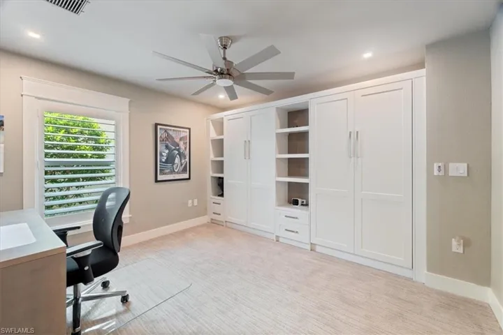 Office space featuring a ceiling fan, light colored carpet, and recessed lighting