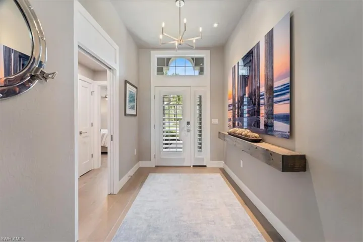 Entryway with a chandelier and light wood finished floors