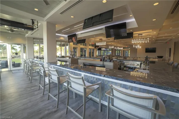 Bar area with wood finished floors, a ceiling fan, and recessed lighting