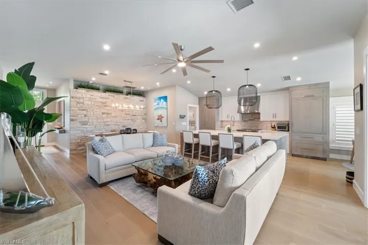 Living room featuring ceiling fan, light wood finished floors, and recessed lighting