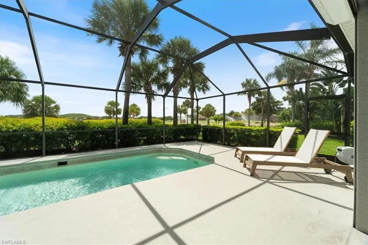 Outdoor pool featuring a patio and glass enclosure