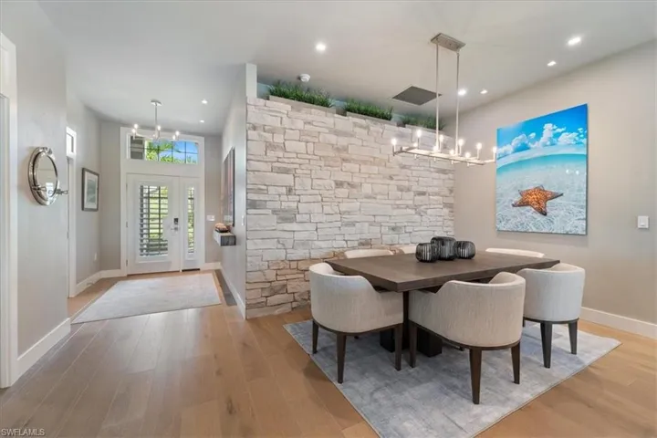 Dining area featuring wood finished floors, a chandelier, and recessed lighting