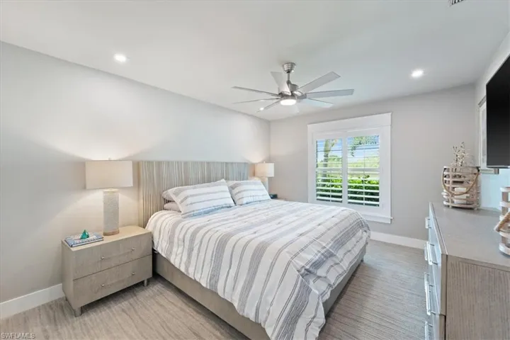 Bedroom with ceiling fan, recessed lighting, and light colored carpet