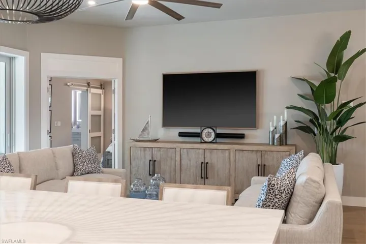 Living room with a ceiling fan and wood finished floors