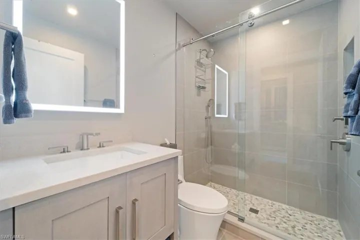 Bathroom with vanity and a stall shower