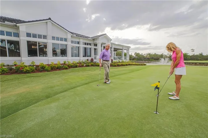 View of home's community featuring an area to practice putting