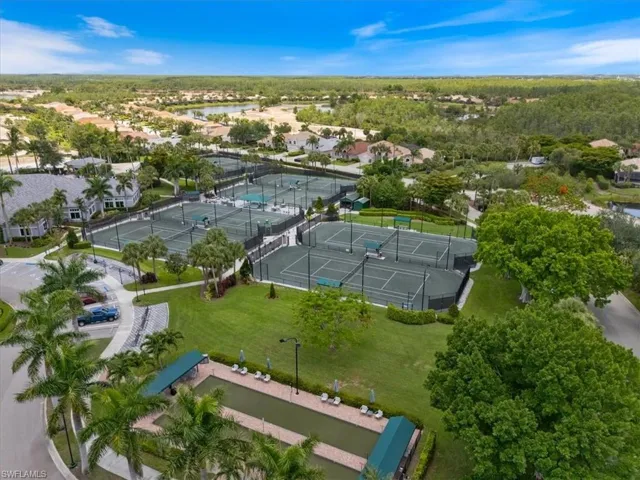 Aerial view of property and surrounding area with nearby suburban area