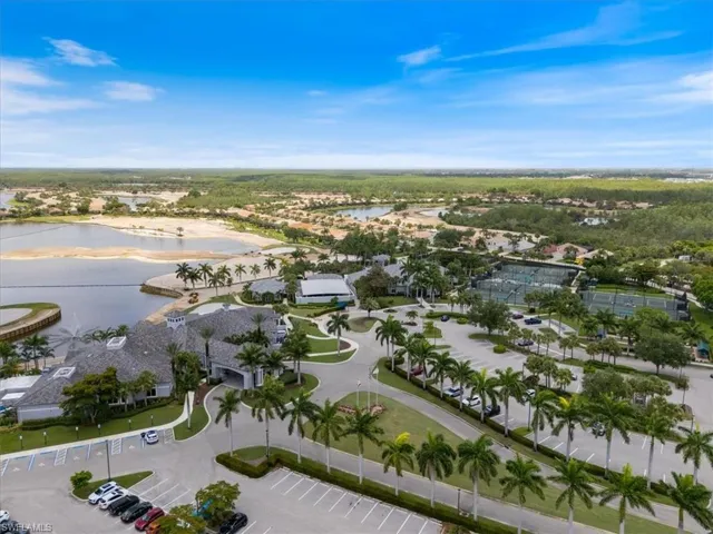 Aerial view of property's location featuring a nearby body of water and nearby suburban area