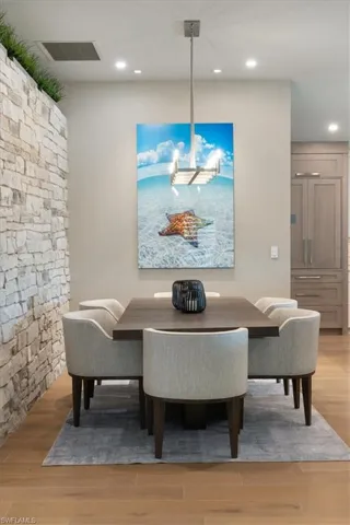 Dining space with recessed lighting and wood finished floors