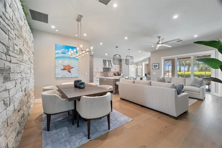 Dining area with a ceiling fan, recessed lighting, and light wood finished floors