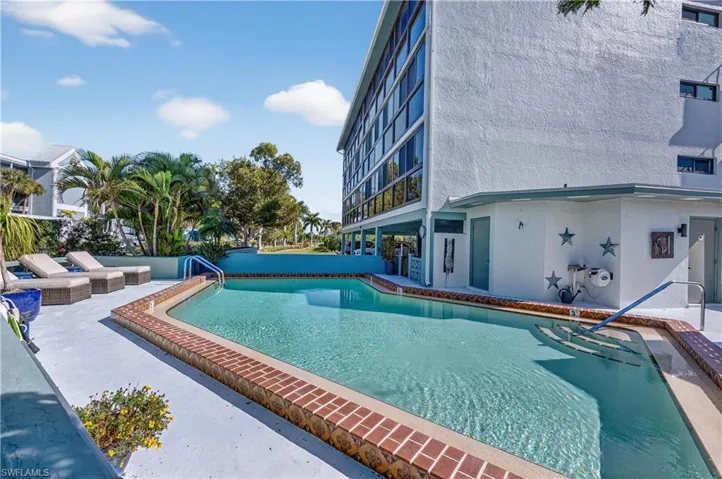 Community pool featuring a patio