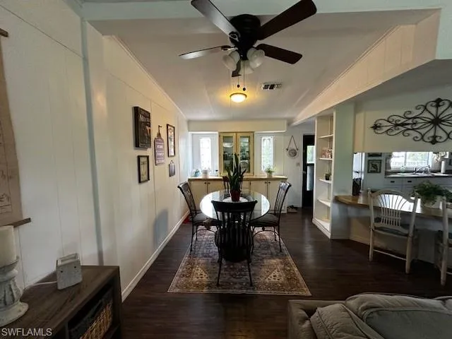 Dining space with french doors, ceiling fan, and dark hardwood / wood-style floors