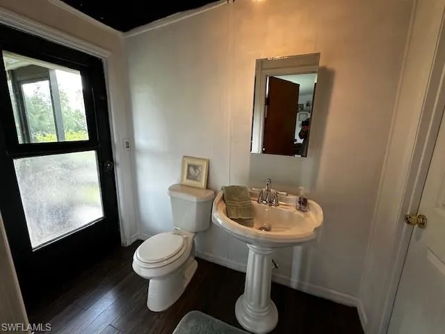 Bathroom featuring hardwood / wood-style floors and toilet